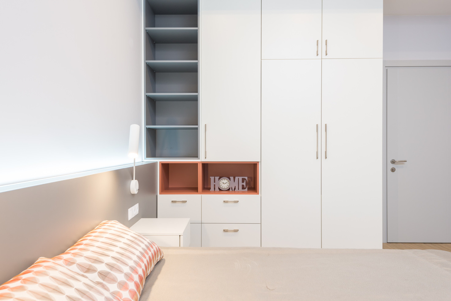 White big closet and comfy bed in light bedroom